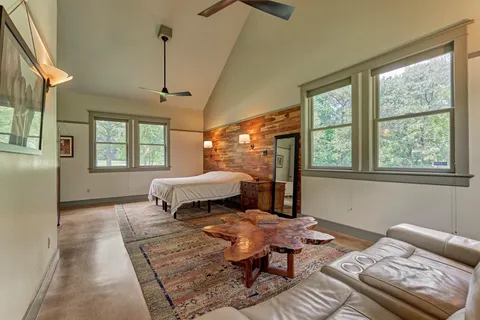 a bedroom with furniture and a window