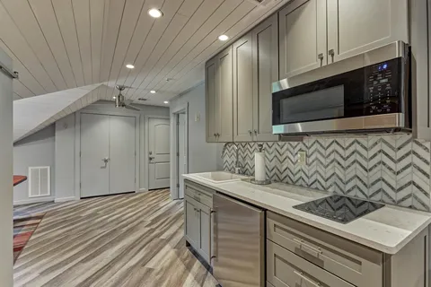 a kitchen with a sink stainless steel appliances and cabinets