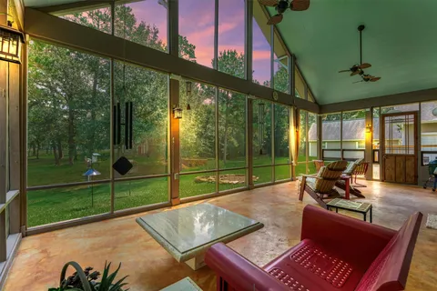 a view of a living room and balcony with furniture