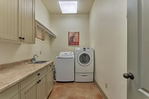 a utility room with a sink a washer and dryer