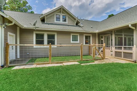 a view of a house with a yard and sitting area