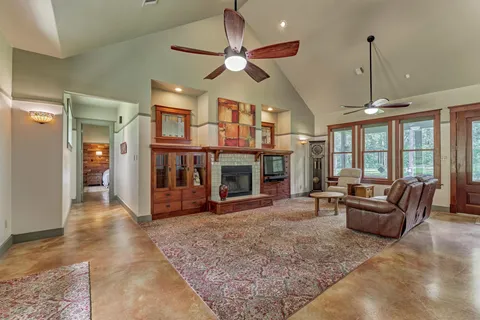 a living room with furniture a window and a fireplace