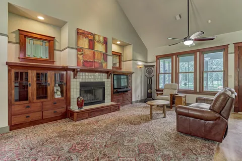 a living room with furniture tv and a fireplace