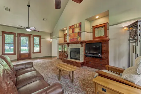 a living room with furniture a fireplace and a flat screen tv