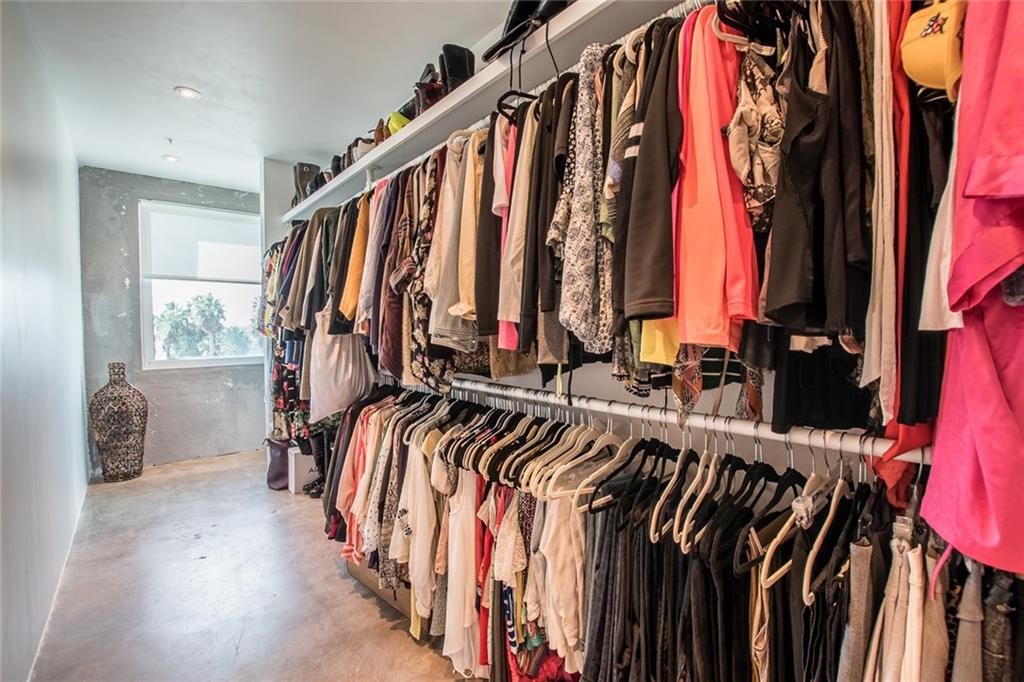 901 North Upper Broadway, Unit 206 Corpus Christi, TX 78401 - Photo 36 of 40 a view of walk in closet with clothes and shoes