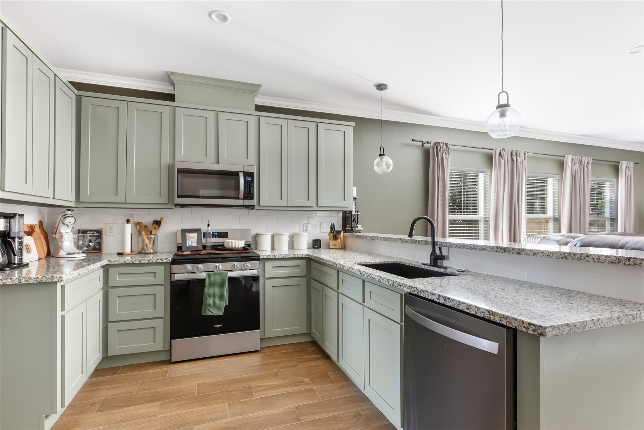 2201 Maple Street Liberty, TX 77575 - Photo 11 of 34 a kitchen with stainless steel appliances granite countertop a sink stove and cabinets