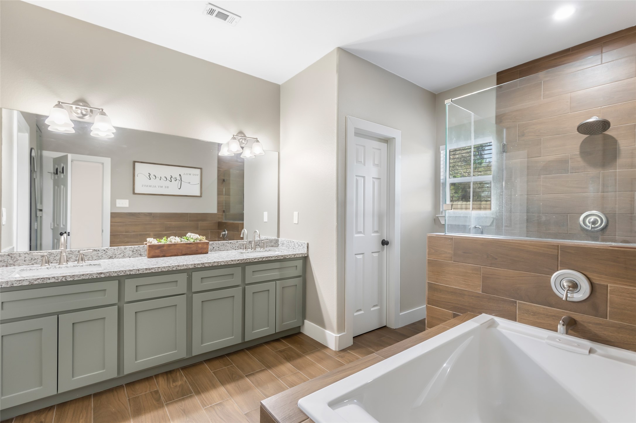 2201 Maple Street Liberty, TX 77575 - Photo 23 of 34 a spacious bathroom with a double vanity sink a mirror and a shower