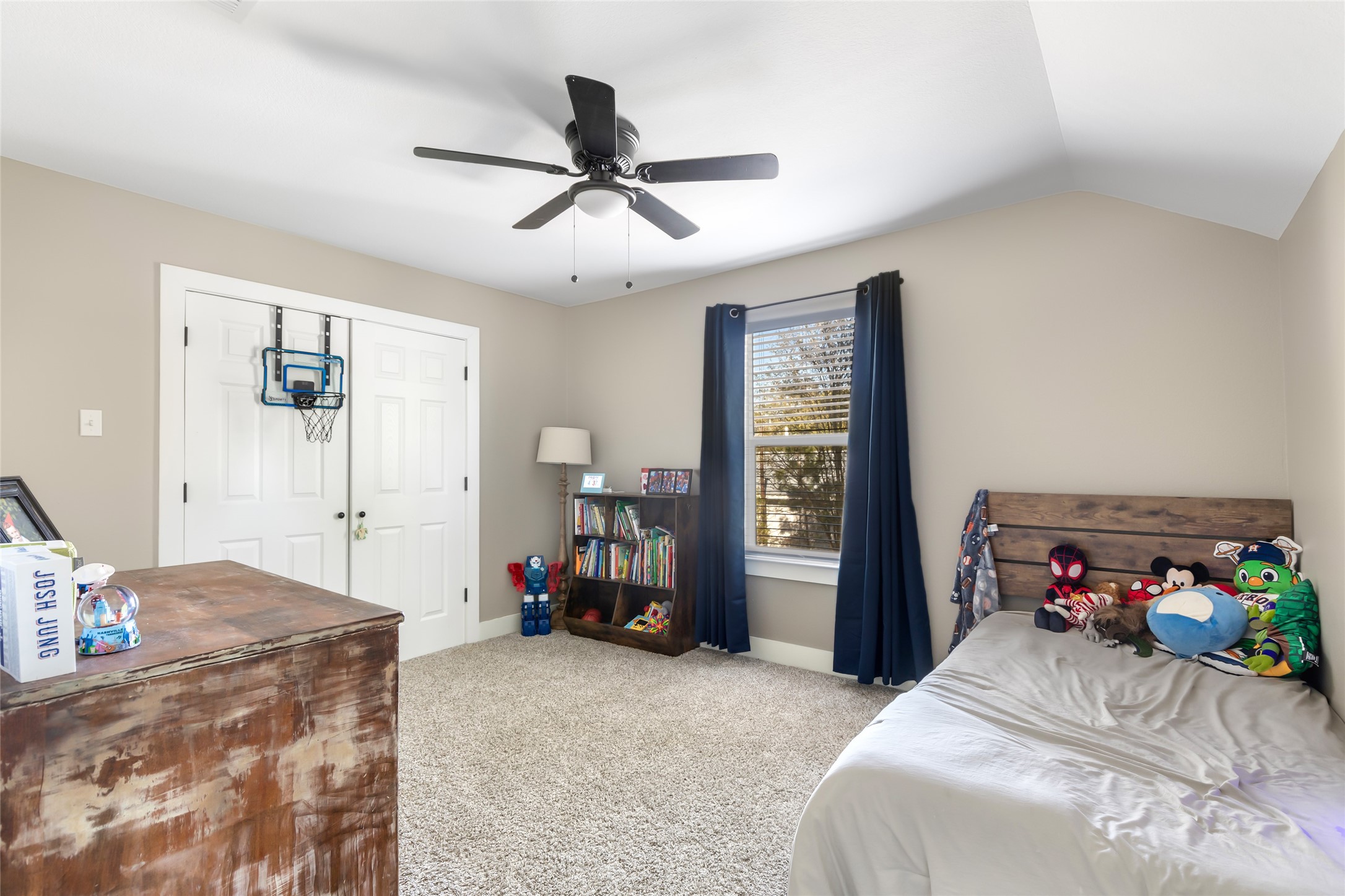 2201 Maple Street Liberty, TX 77575 - Photo 27 of 34 a bedroom with a bed and a chandelier