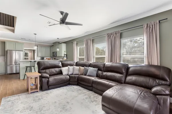 a utility room with lots of clutter and refrigerator