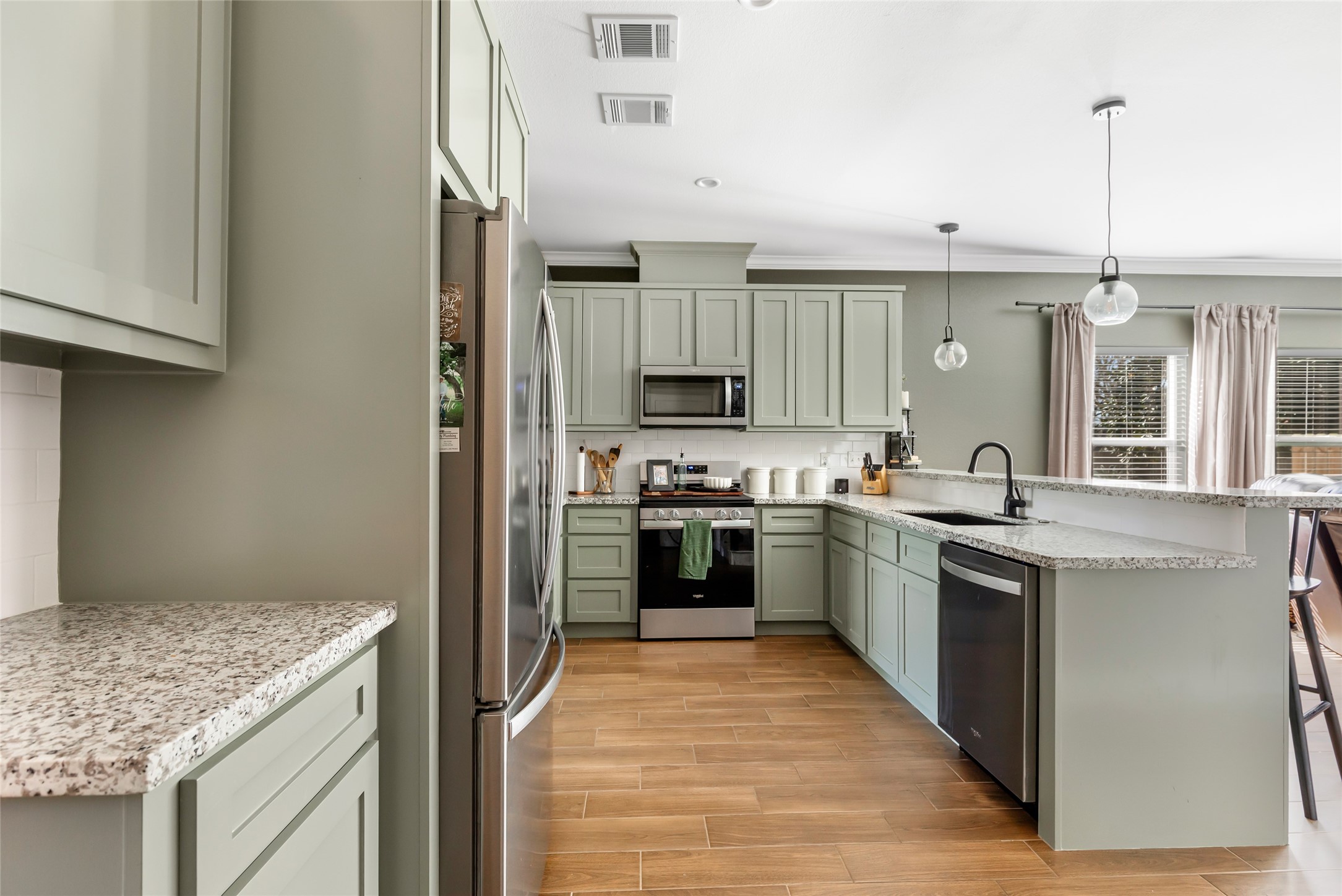 2201 Maple Street Liberty, TX 77575 - Photo 10 of 34 a kitchen with granite countertop a stove top oven and sink