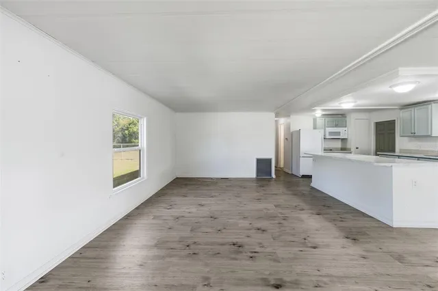 a large kitchen with stainless steel appliances kitchen island a large counter top and a stove top oven