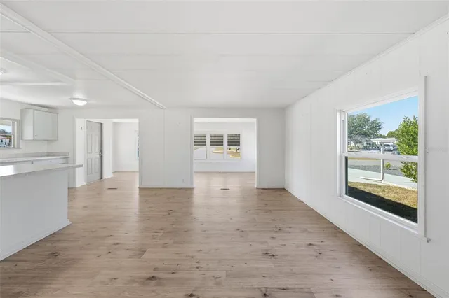 a kitchen with granite countertop a sink stove and cabinets