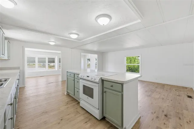 a large white kitchen with a large window