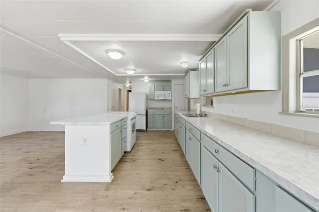 a view of a room with wooden floor and furniture