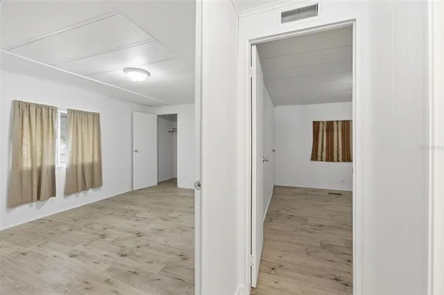 a view of a livingroom with a piano and wooden floor