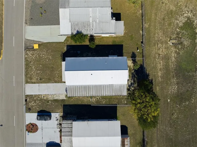 a view of balcony with two potted plants and large trees