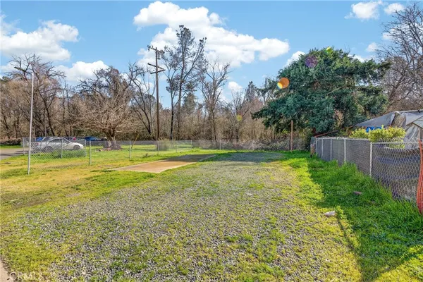 a white house that has a tree in front of it