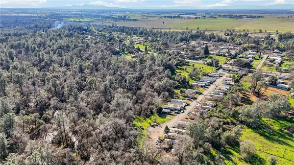 an aerial view of a house with a big yard