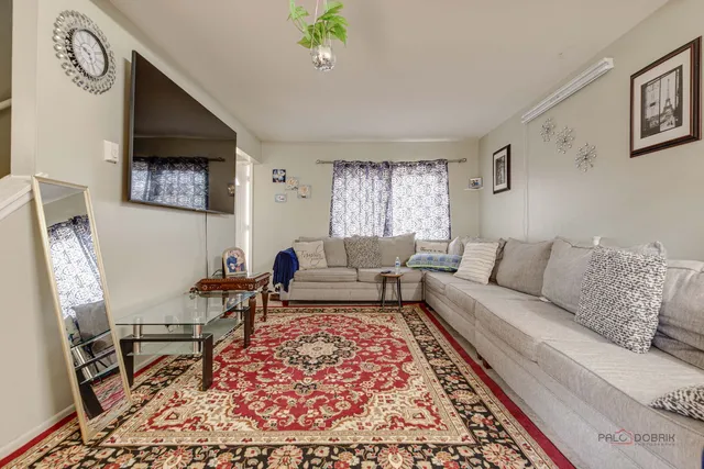 a living room with furniture and a rug