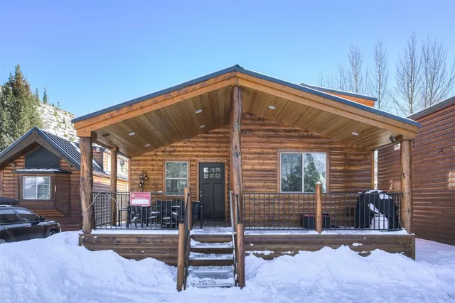 a kitchen with stainless steel appliances a dining table chairs stove and refrigerator