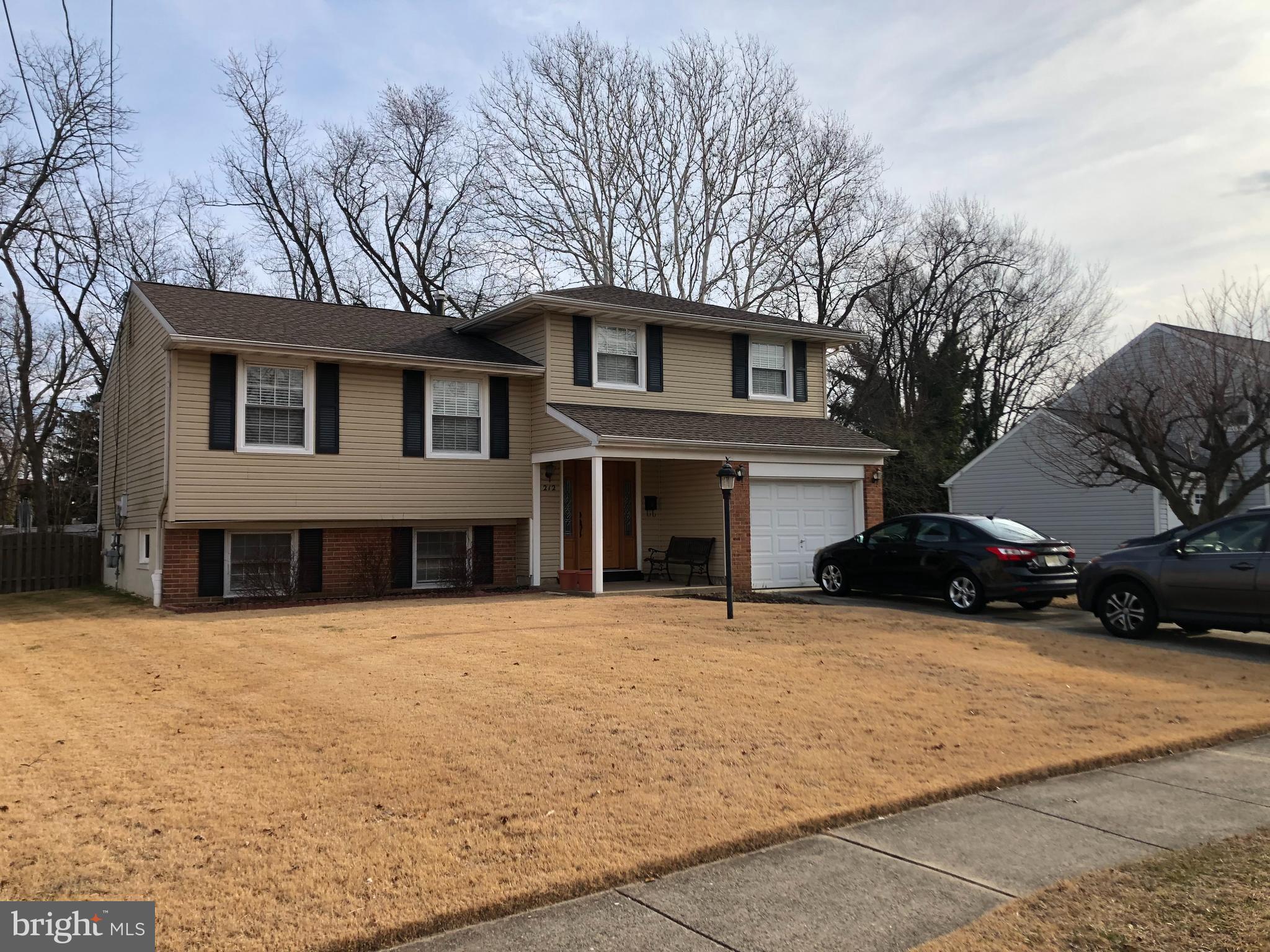 212 Winding Way Road Stratford, NJ 08084 - Photo 2 of 2 a house that has a tree in front of it