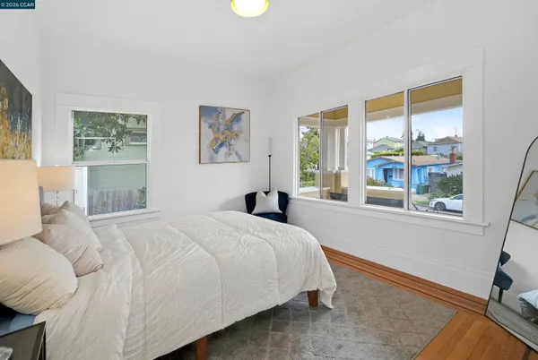 a bedroom with a bed and a large window