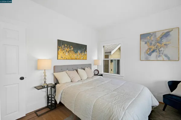 a bedroom with a bed and a painting on the wall