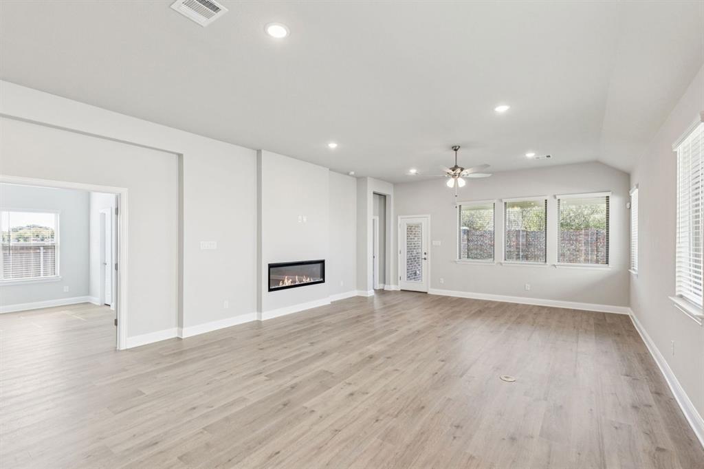 4504 Snakeweed Street Fort Worth, TX 76036 - Photo 16 of 30 a view of an empty room with wooden floor and a window