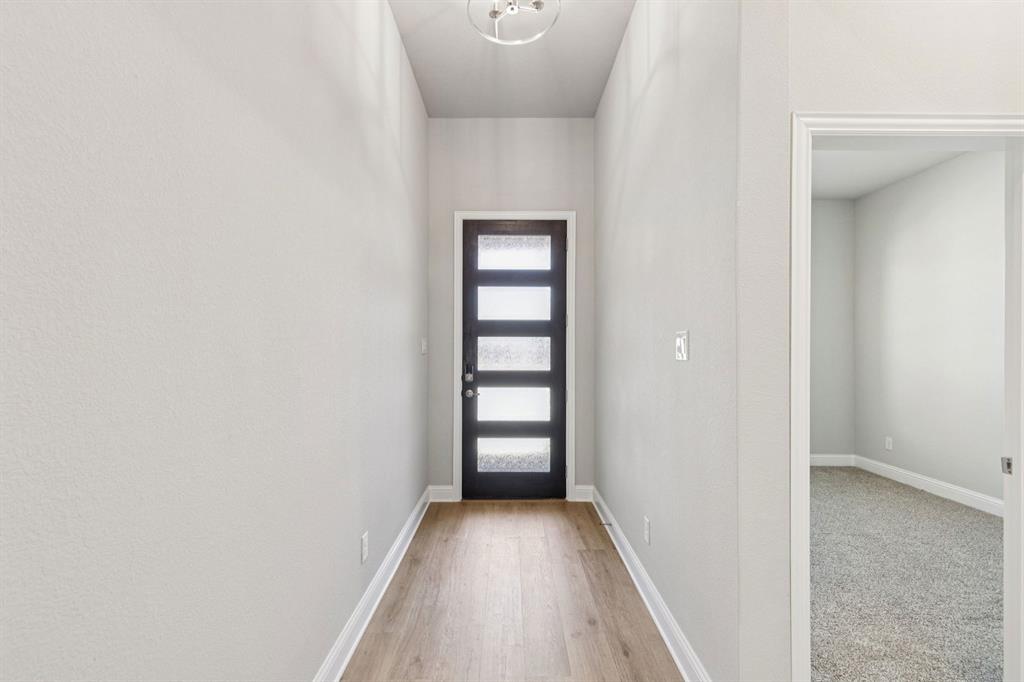 4504 Snakeweed Street Fort Worth, TX 76036 - Photo 2 of 30 a view of a hallway with wooden floor and closet