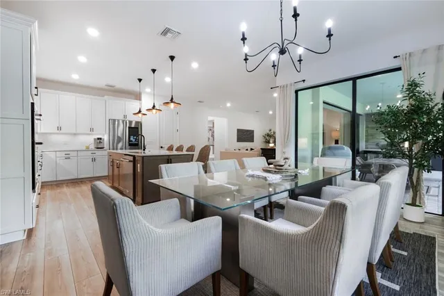 a large kitchen with a table and chairs