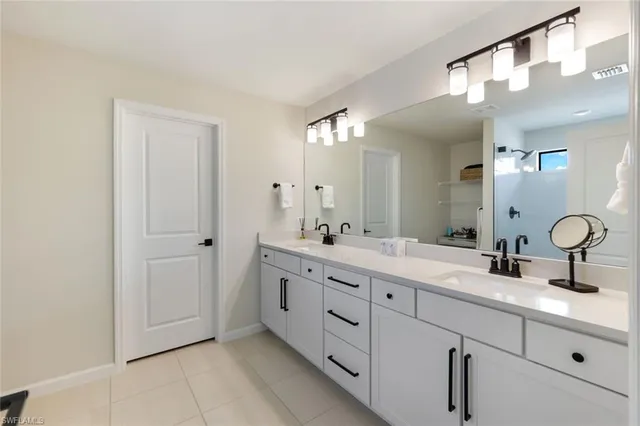a bathroom with a double vanity sink and a mirror