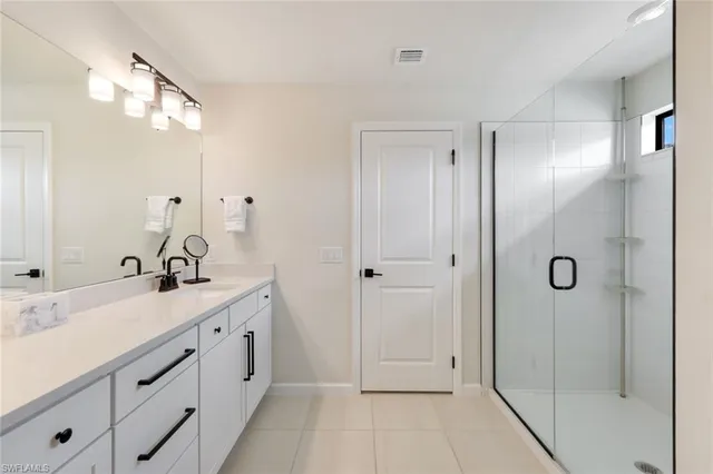 a bathroom with a double vanity sink mirror and shower