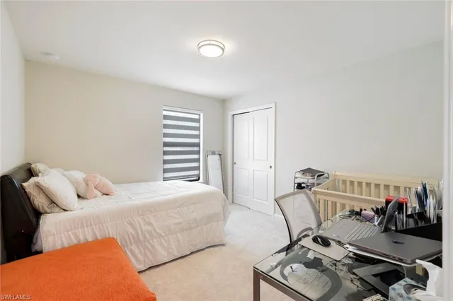 a bedroom with a bed and a couch