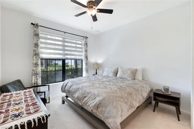 a bedroom with a bed and a night stand