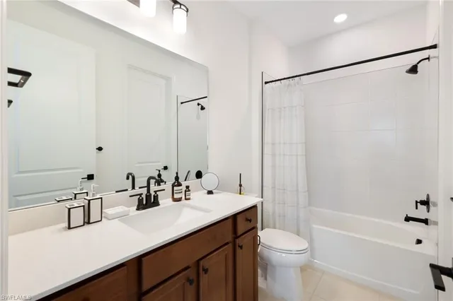 a bathroom with a sink double vanity mirror and toilet