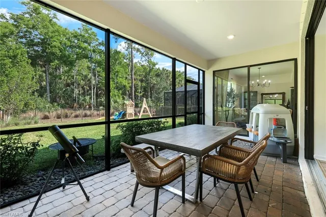 a view of a patio with a table chairs and a backyard