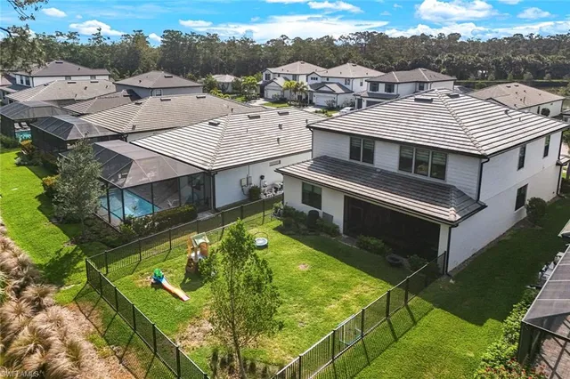 an aerial view of residential houses with yard