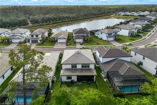 an aerial view of a house with garden space and lake view