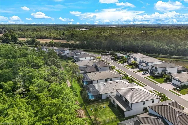 an aerial view of a residential houses with city view