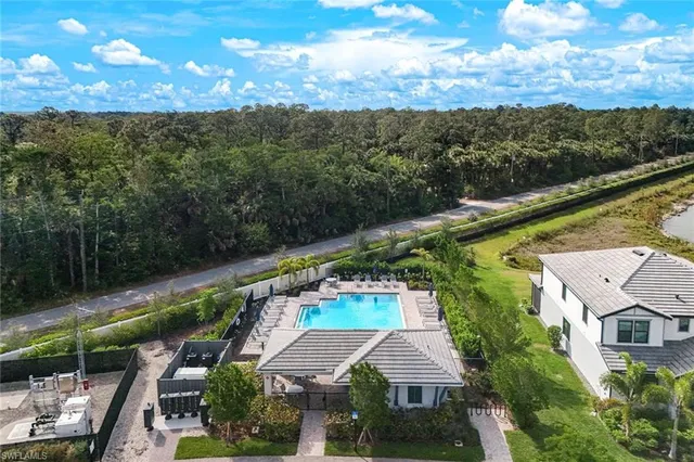 a view of a house with a yard and a pool