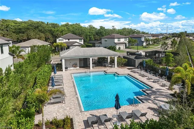 an aerial view of house with yard swimming pool and mountains
