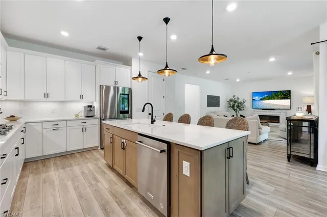 a kitchen with stainless steel appliances kitchen island a large island in the center