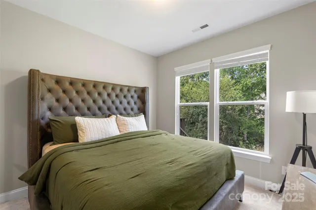 a bedroom with a large bed and a large window