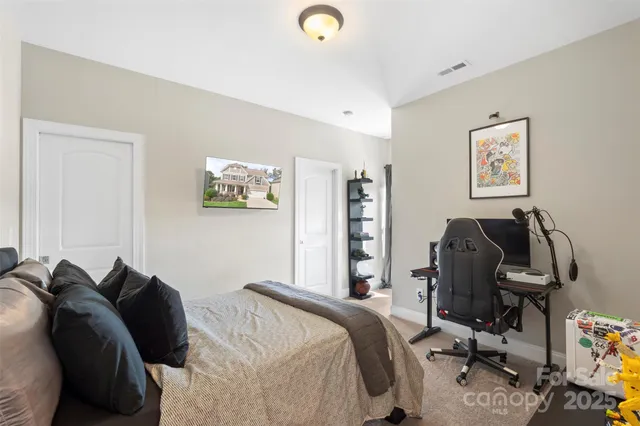 a bedroom with a bed and a desk