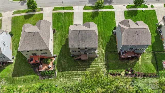 an aerial view of a house with a garden and trees