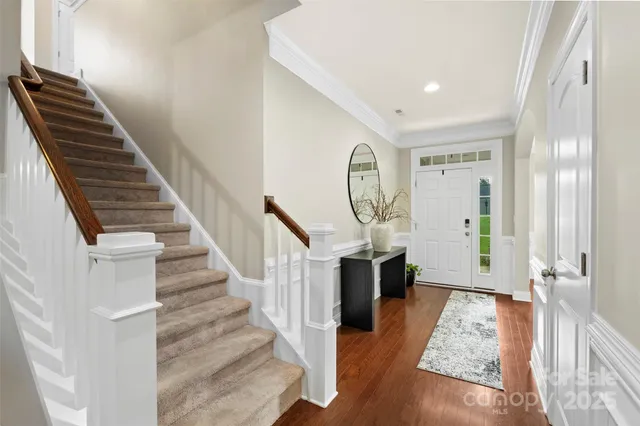 a view of entryway and hall with wooden floor