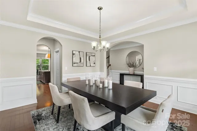 a dining room with furniture a window and a chandelier
