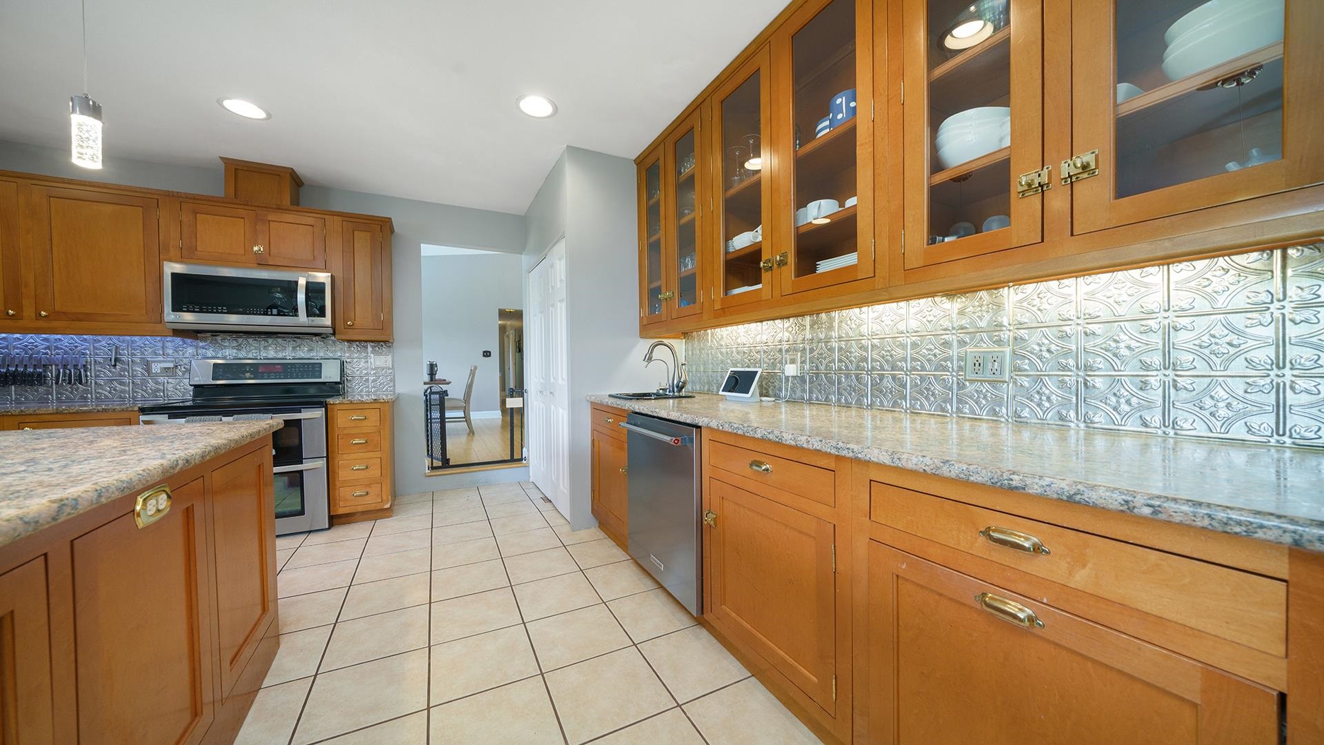 3300 North Silver Ridge Drive Oregon, IL 61061 - Photo 12 of 56 a kitchen with stainless steel appliances granite countertop a stove and a sink
