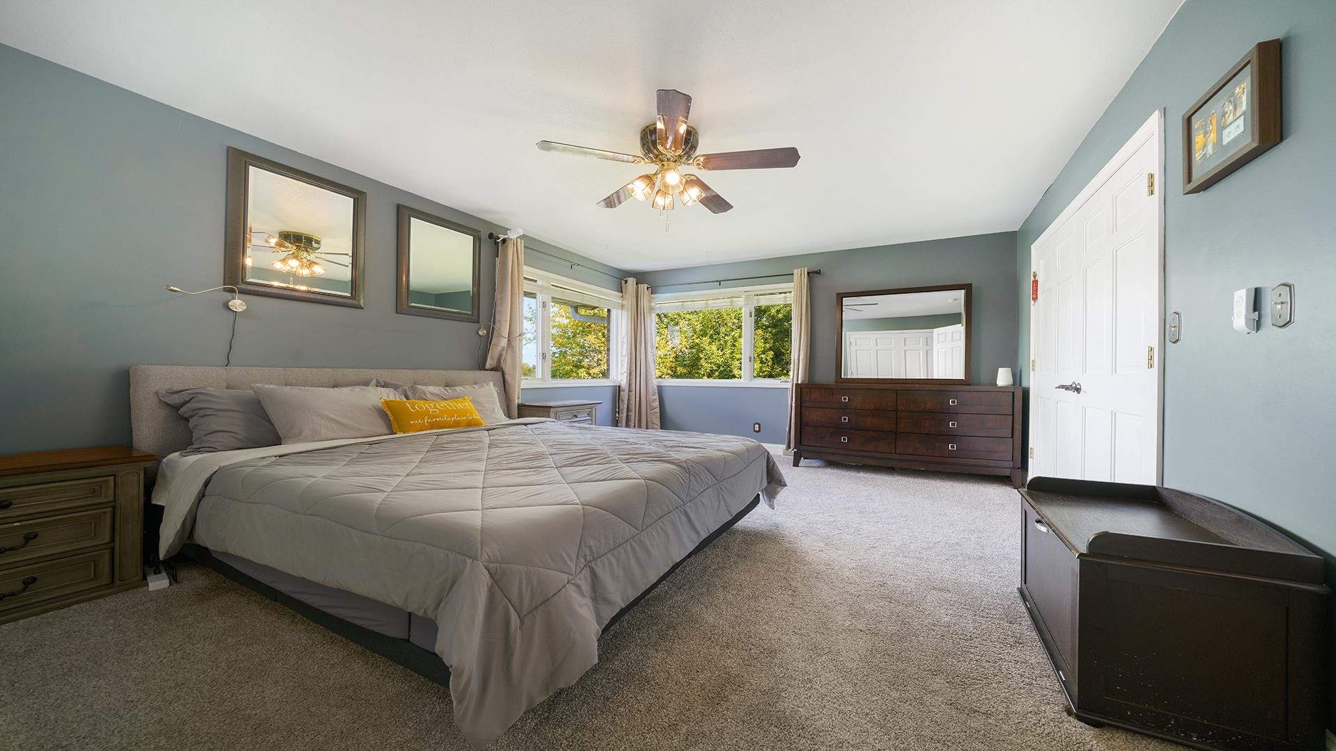 3300 North Silver Ridge Drive Oregon, IL 61061 - Photo 22 of 56 a spacious bedroom with a bed and dresser with mirror