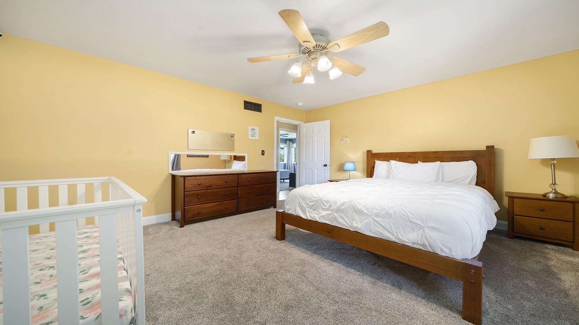 3300 North Silver Ridge Drive Oregon, IL 61061 - Photo 29 of 56 a spacious bedroom with a bed and a chandelier